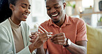 Happy, couple and learning at house with chopsticks, technique and assistance for new skill. Black people, laugh and help with sticks for dining etiquette, Japanese customs and bonding for tradition