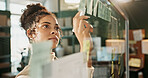 Glass wall, planning and sticky notes with woman in logistics warehouse for supply chain schedule. Ecommerce, storyboard and writing with employee in office for delivery or distribution strategy