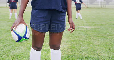 Buy stock photo Rugby, ball and hands of woman on field for competition practice, sports tournament and fitness. Training, wellness and game challenge with legs of person outdoor for club, athlete and commitment