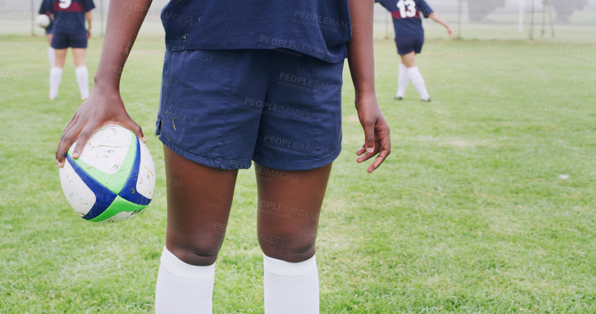 Buy stock photo Rugby, ball and hands of woman on field for competition practice, sports tournament and fitness. Training, wellness and game challenge with legs of person outdoor for club, athlete and commitment