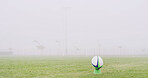 Rugby, mist and fitness with ball on field for competition practice, kick off and sports tournament. Game event, match pitch and fog with equipment in stadium outdoor for mockup, hobby and score