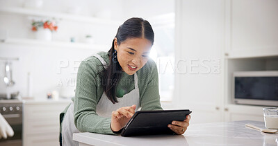 Buy stock photo Baking, internet or Asian woman with tablet in kitchen, meal inspiration or smile for cuisine tutorial. Flare, tech or person with research for ingredients swap, food blog or cooking video in home