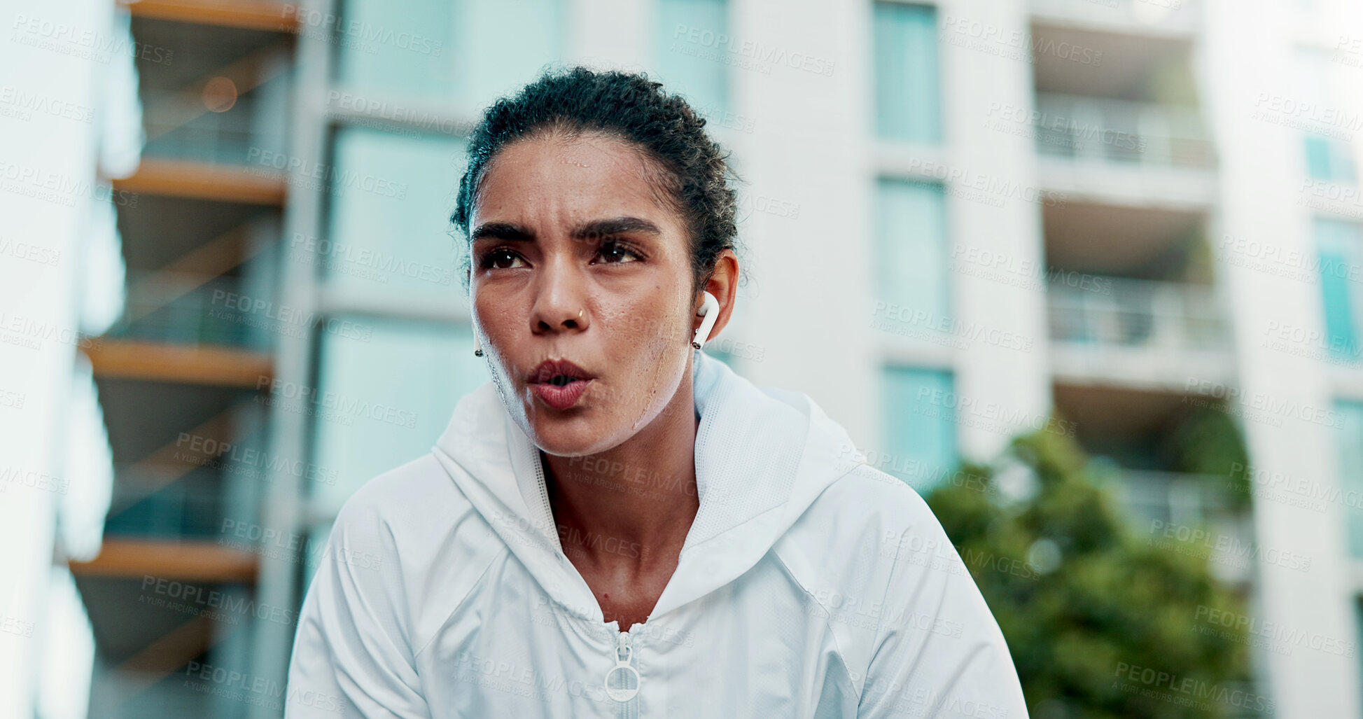 Buy stock photo Breathing, fitness and woman in city with break for exercise, cardio training and wellness. Earphones, athlete and female person with rest in urban town for workout, health or active with sports.