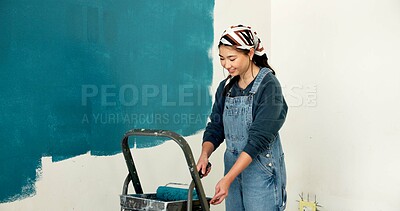 Buy stock photo Woman, wall and painting for renovation with smile, roller and color for property development. Person, interior design, tools and equipment with application, space and ladder for home improvement