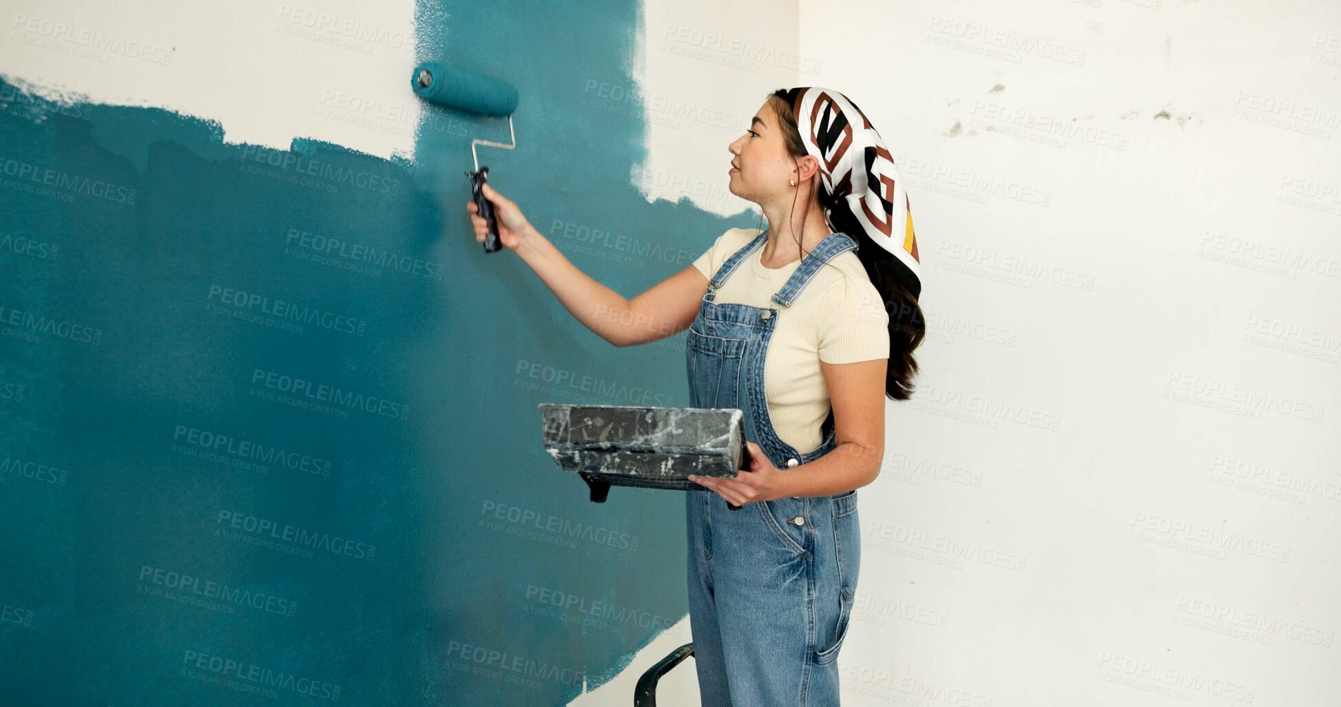 Buy stock photo Woman, roller and painting for renovation with wall, space and color for property development. Person, interior design, tools and equipment with application, smile and ladder for home improvement