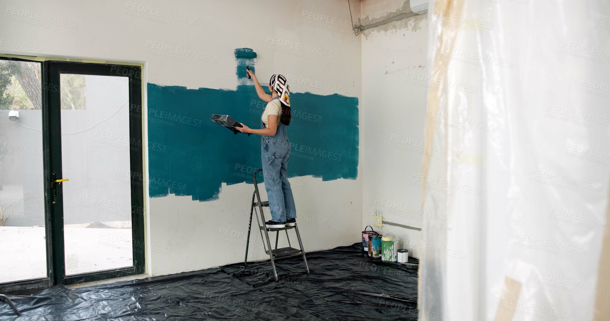 Buy stock photo Woman, ladder and painting for renovation with wall, creative and color for property development. Person, interior design, tools and equipment with stroke, maintenance and brush for home improvement