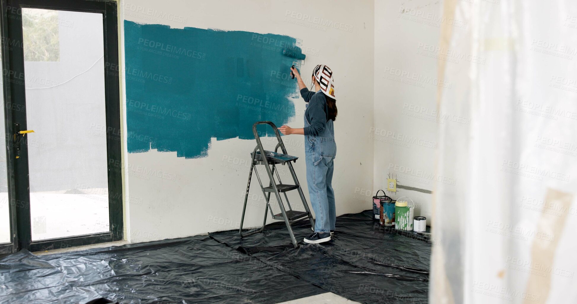 Buy stock photo Woman, ladder and painting wall in house, creative or renovation with space for property development. Person, interior design, tools and gear with back, maintenance and brush for home improvement
