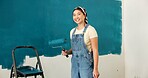 Happy woman, portrait and painting wall for renovation, roller or color for property development. Girl, interior design and gear with brush, space or ladder for home improvement project in Indonesia