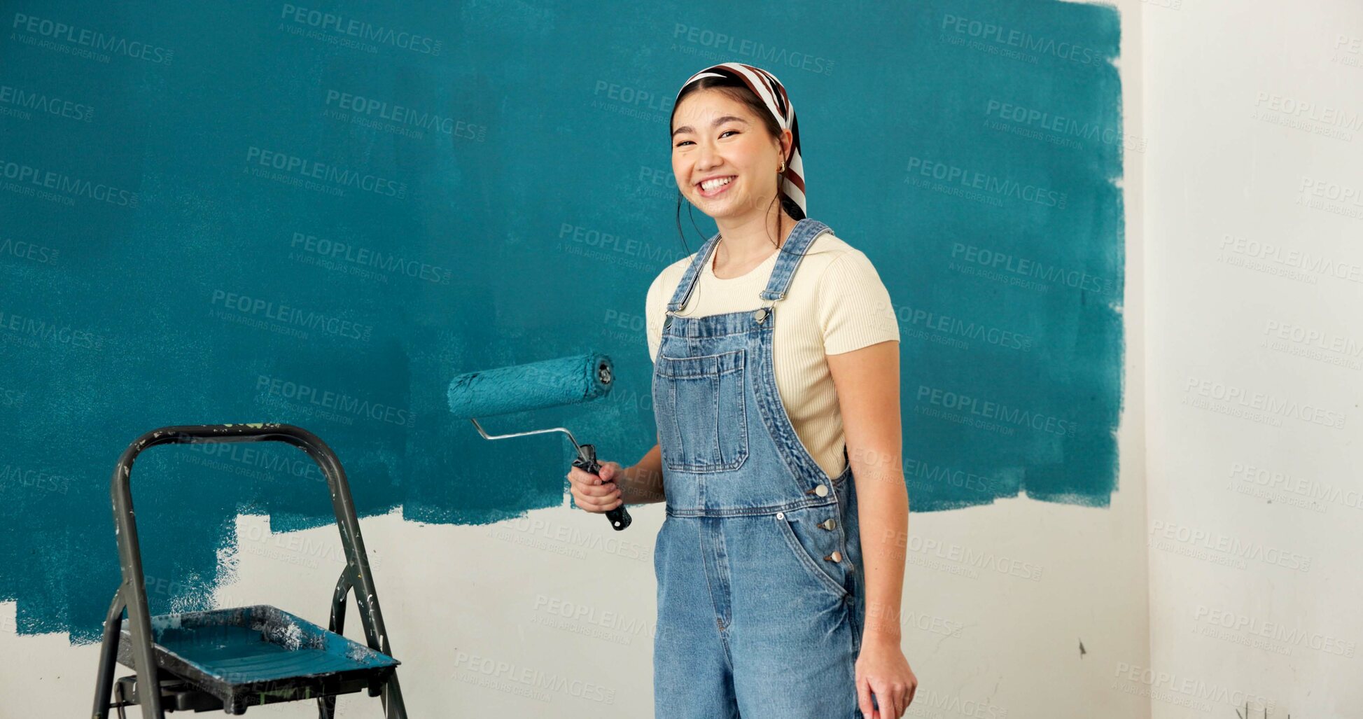 Buy stock photo Happy woman, portrait and painting wall for renovation, roller or color for property development. Girl, interior design and gear with brush, space or ladder for home improvement project in Indonesia