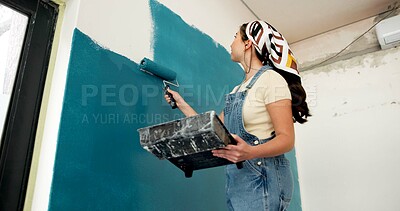 Buy stock photo Woman, roller and painting wall with renovation, creative and low angle for property development. Person, interior design and equipment with stroke, maintenance gear and brush for home improvement