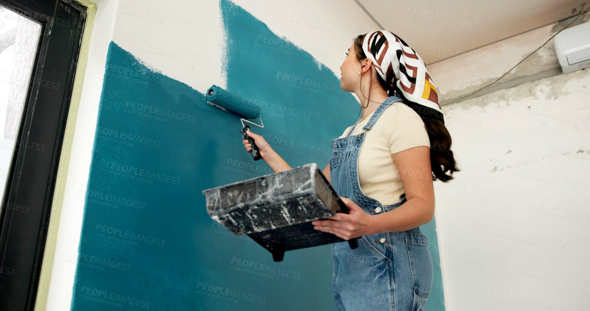 Buy stock photo Woman, roller and painting wall with renovation, creative and low angle for property development. Person, interior design and equipment with stroke, maintenance gear and brush for home improvement
