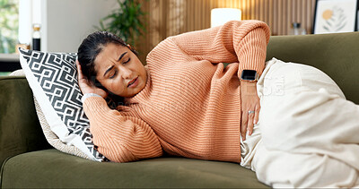 Buy stock photo Woman, sickness and rest on sofa with stomach pain, menstruation cramps and IBS symptoms in home. Person, stress and discomfort in living room with tummy ache, endometriosis and celiac complication
