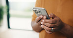 Man, hands and typing with phone in home for social media, communication or network connection. Male person, chatting or texting with mobile smartphone for internet, app or online service in house