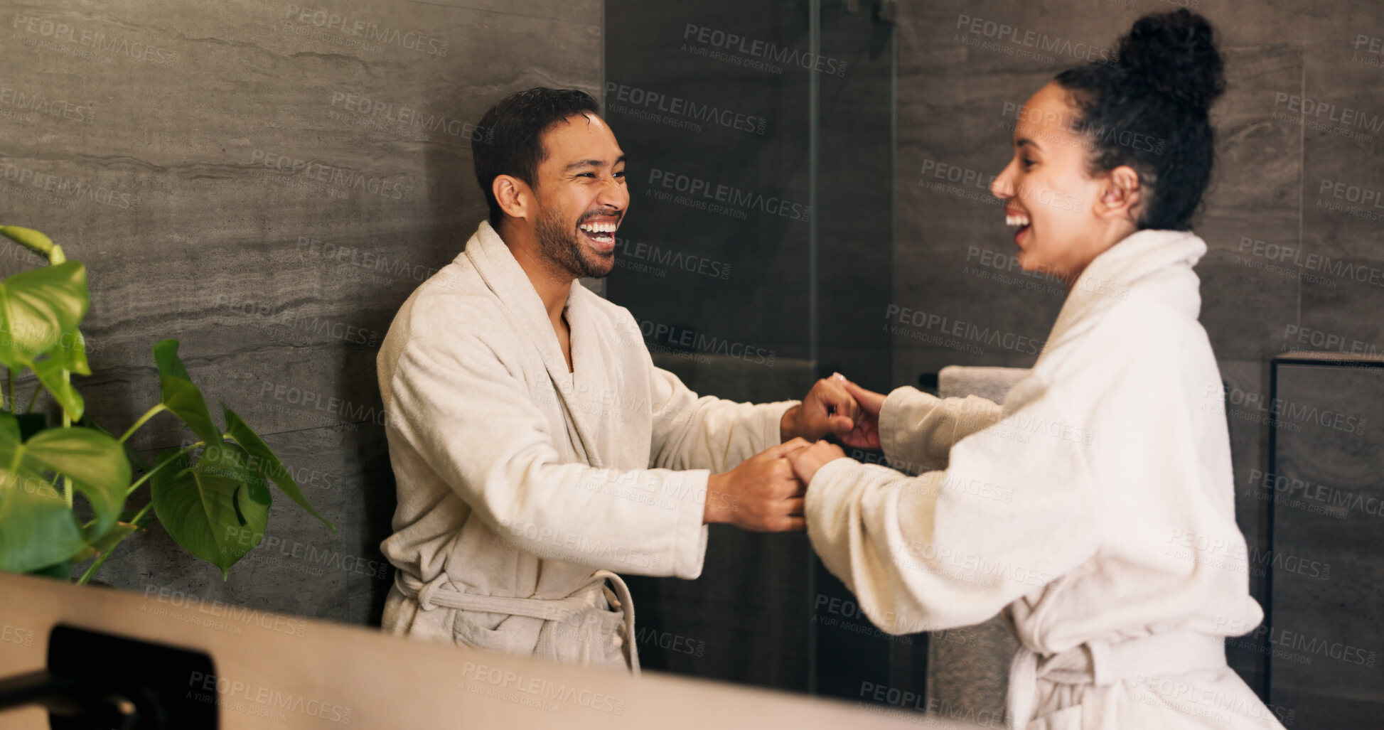 Buy stock photo Bathroom, happy couple and dance by mirror, holding hands and laughing together with love. Excited people, music and rhythm in home with reflection, funny and relationship wellness with partner