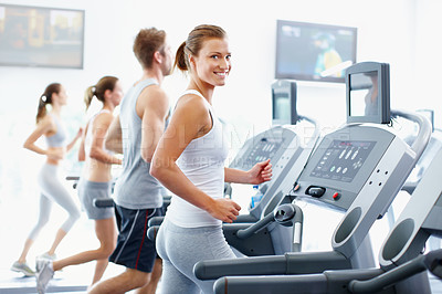 Buy stock photo Portrait of an attractive young woman jogging on a treadmill