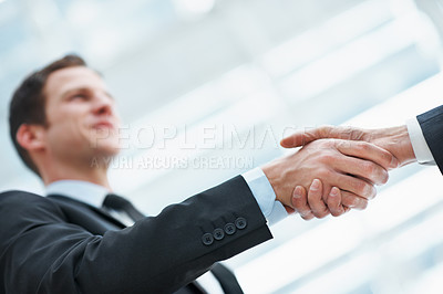 Buy stock photo Handshake, deal and business man in office with financial merger, collaboration or agreement. Shaking hands, low angle and people with investment acquisition, partnership or corporate consolidation