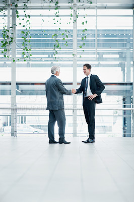 Buy stock photo Businessmen, meeting and deal with handshake for corporate partnership together in office. Male people, employees or colleagues shaking hands with introduction or greeting for b2b agreement on space
