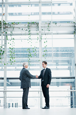 Buy stock photo Businessmen, meeting or partnership with handshake for corporate deal together in office. Male people, employees or colleagues shaking hands with introduction or greeting for agreement or negotiation