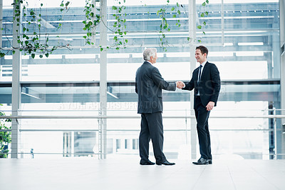 Buy stock photo Businessmen, meeting or partnership with handshake for hiring or corporate deal together in office. Male people, employees or colleagues shaking hands with introduction for recruiting or agreement