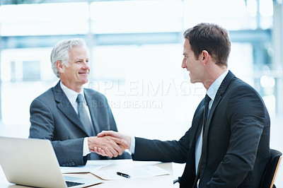 Buy stock photo Happy, businessmen or meeting with handshake in office for deal, partnership or hiring. Male people, employees or colleagues shaking hands with smile, laptop or documents for recruiting or agreement