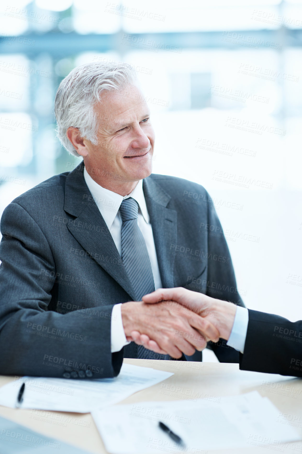 Buy stock photo Happy, businessman or meeting with handshake for hiring, deal or partnership together in office. Man, executive or shaking hands with smile or documents for legal agreement or recruiting in workplace