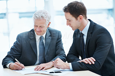 Buy stock photo Meeting, people and sign document at law firm for settlement agreement, lawyer approval and compliance. Attorney, men and paperwork signature in office for court case admin, policy and cooperation.