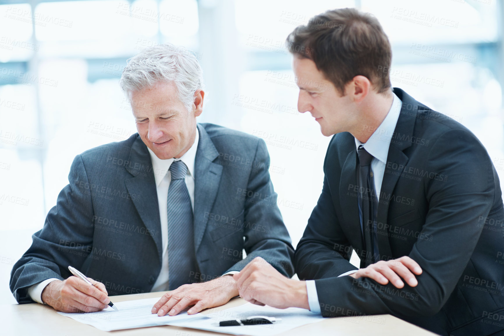 Buy stock photo Meeting, people and sign paperwork in law firm for settlement agreement, lawyer approval and compliance. Attorney, men and document signature in office for court case admin, policy and cooperation.