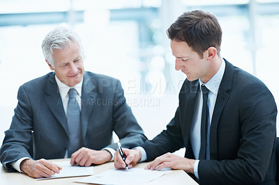 Buy stock photo People, meeting and document signature in office with attorney, form and petition for lawsuit review. Lawyer, men and sign court case appeal paperwork for legal decision, compliance and cooperation.
