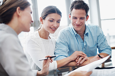 Buy stock photo Finance, happy couple and paperwork in office with consultant, insurance update and holding hands. Document, married people and broker in meeting for investment guide to qualify for premium cover