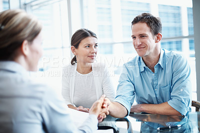 Buy stock photo Couple, deal and handshake with financial advisor for agreement, consulting or investment. Finance, meeting or thank you and broker shaking hands with people in office for portfolio growth or success