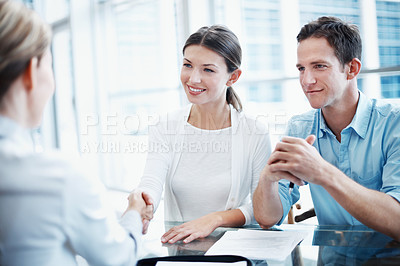 Buy stock photo Couple, handshake and thank you with financial advisor for agreement, consulting or investment. Deal, finance or meeting and broker shaking hands with people in office for portfolio growth or success