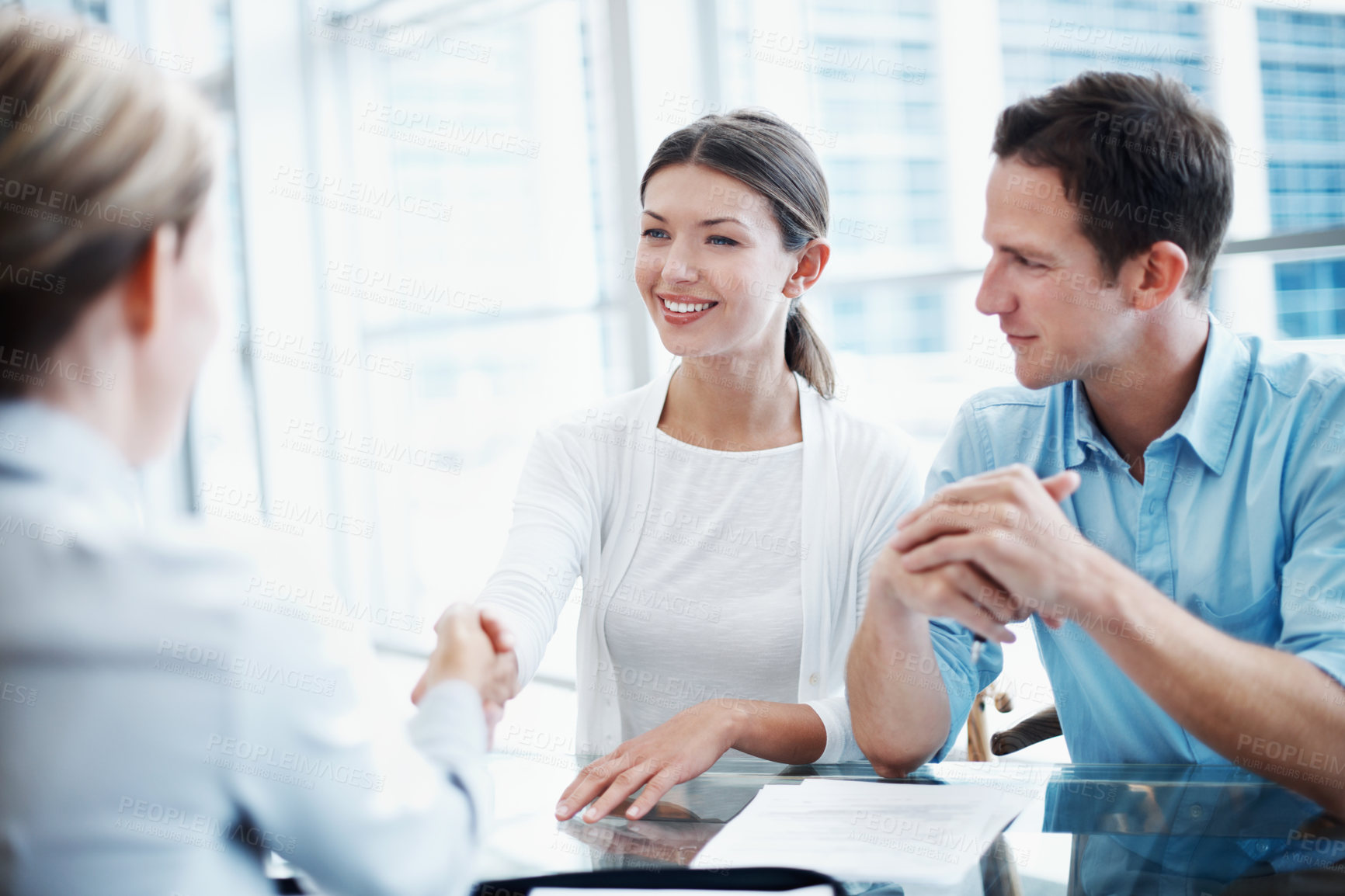 Buy stock photo Couple, handshake and meeting with financial advisor for agreement, consulting or investment. Deal, finance or thank you and broker shaking hands with people in office for portfolio growth or success
