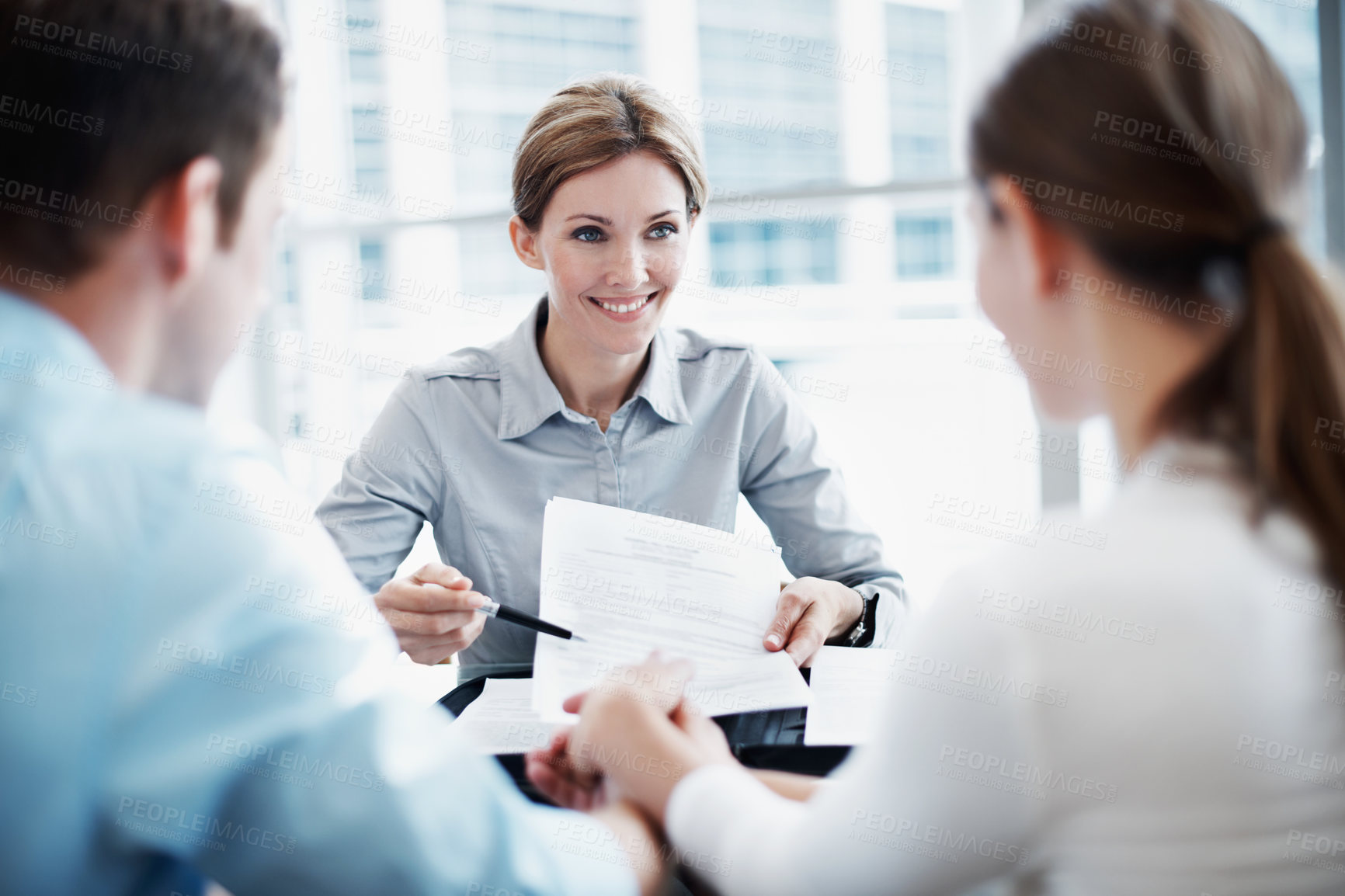 Buy stock photo Document, couple and insurance advisor, holding hands and smile with application for policy. Man, woman and consultation with clients, paperwork and coverage contract for future protection in office