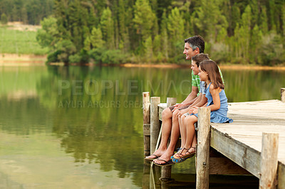 Buy stock photo Thinking, father and smile with children at lake, sightseeing and bonding together on holiday. Man, relax and space on pier with kids, family getaway and weekend break on vacation for exploring view