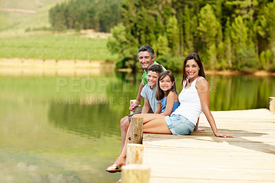Buy stock photo Family, portrait and smile on dock for holiday with love, bonding and relax in nature together. Happy mother, father and children on pier outdoor for vacation, summer trip and travel with lake space