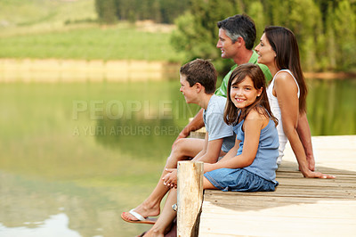 Buy stock photo Parents, children and pier by lake with summer holiday, relax and bonding together for weekend break. Space, mother and father outdoor by river with kids, care and happy family portrait for vacation.