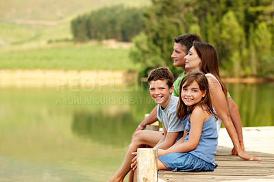 Buy stock photo Parents, children and pier by river with summer holiday, relax and bonding together for weekend break. Space, mother and father outdoor by lake with kids, care and happy family portrait for vacation.