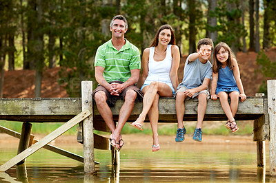 Buy stock photo Family, portrait and smile on dock for vacation with forest, bonding and relax in nature together. Happy mother, father and children with pier outdoor for holiday, summer trip and travel with lake