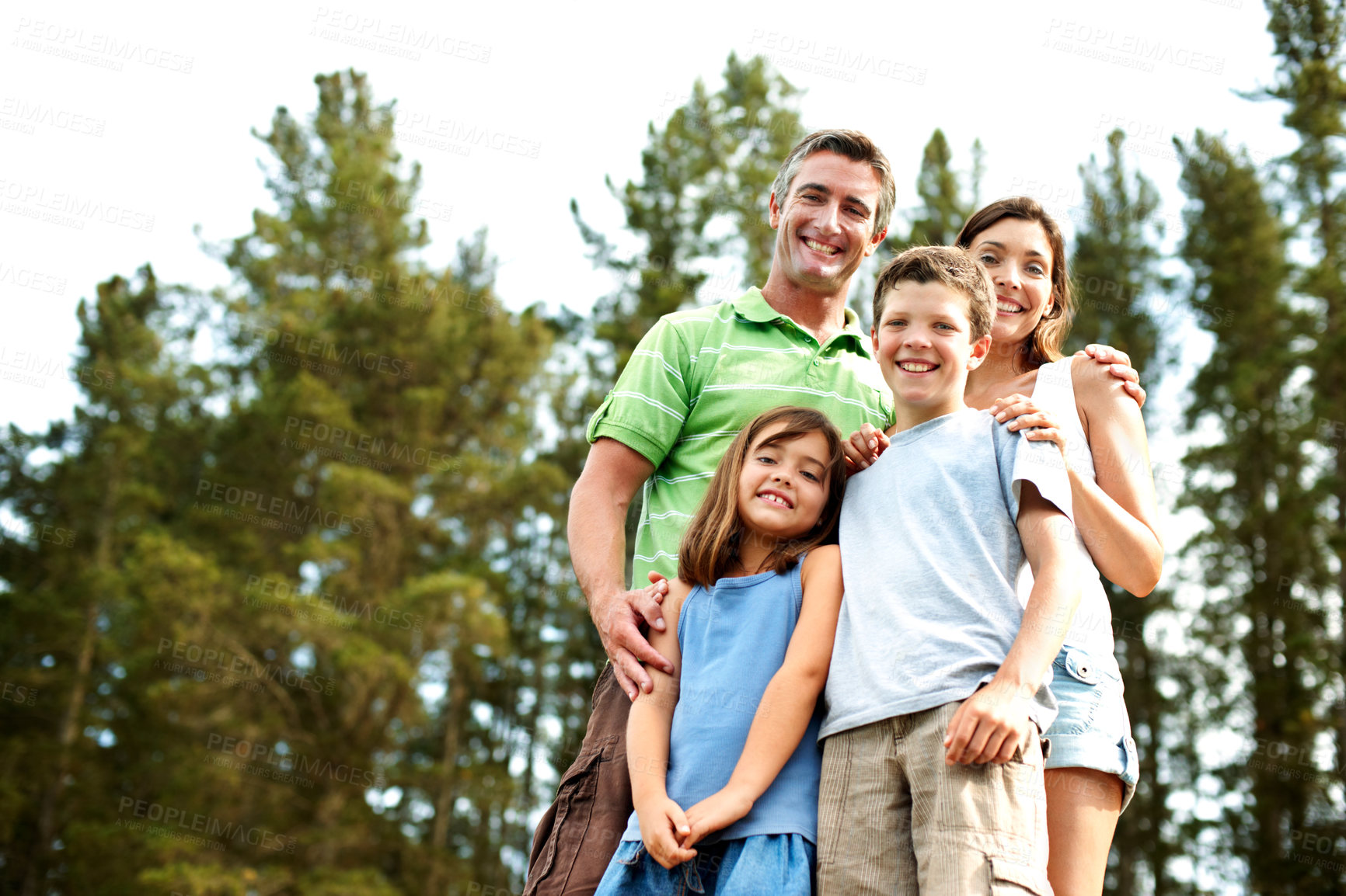 Buy stock photo Family, portrait and relax in woods for vacation with camping, bonding and smile in nature together. Mother, father and children with low angle space for holiday, summer trip or travel in countryside
