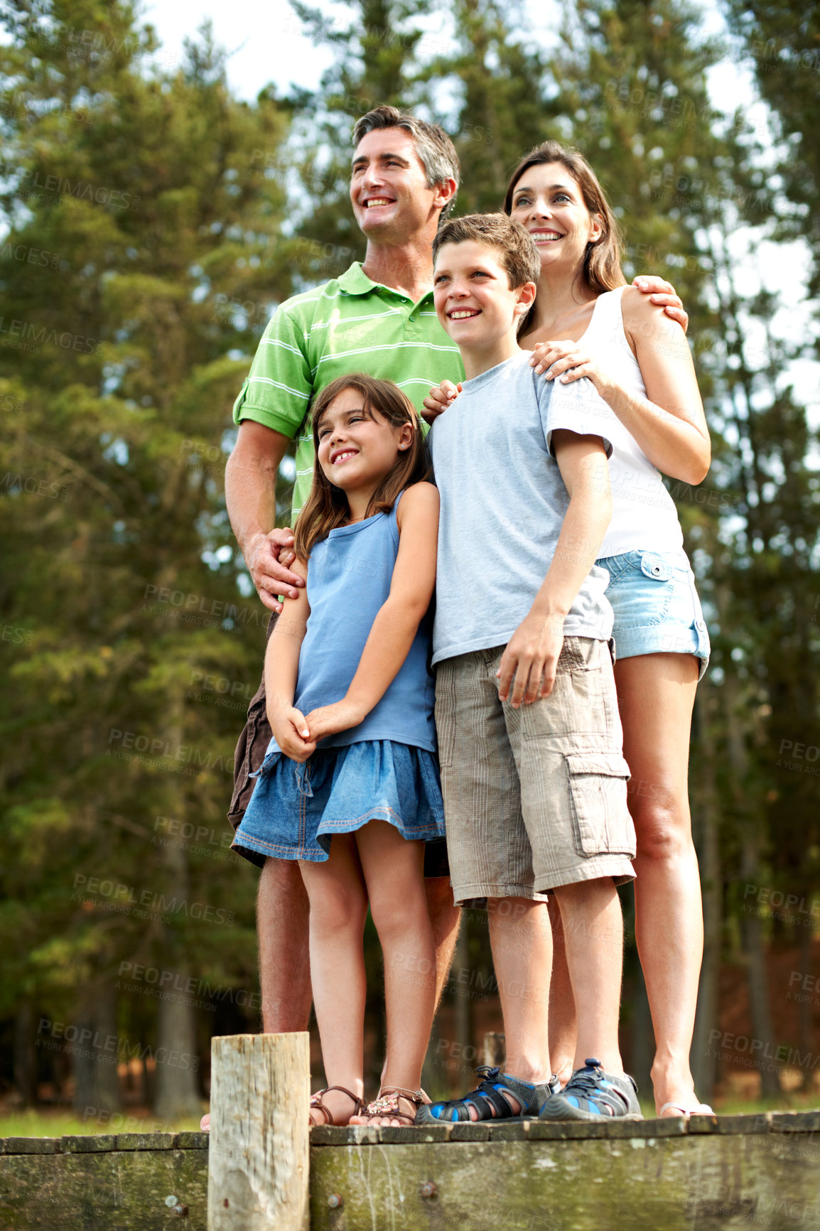 Buy stock photo Holiday, lake and happy family with children in nature for outdoor bonding, weekend or getaway. Mom, dad and kids with smile on lakeside bridge for sightseeing adventure, travel or vacation together