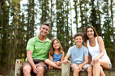 Buy stock photo Family, portrait and relax on pier for vacation with countryside, bonding and smile in nature together. Mother, father and children with dock outdoor for holiday, summer trip and travel with forest