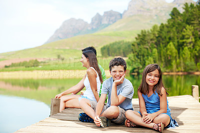 Buy stock photo Children, portrait and smile on dock for vacation with countryside, bonding and relax in nature together. Family, brother and sister with jetty outdoor for holiday, summer trip and travel by lake