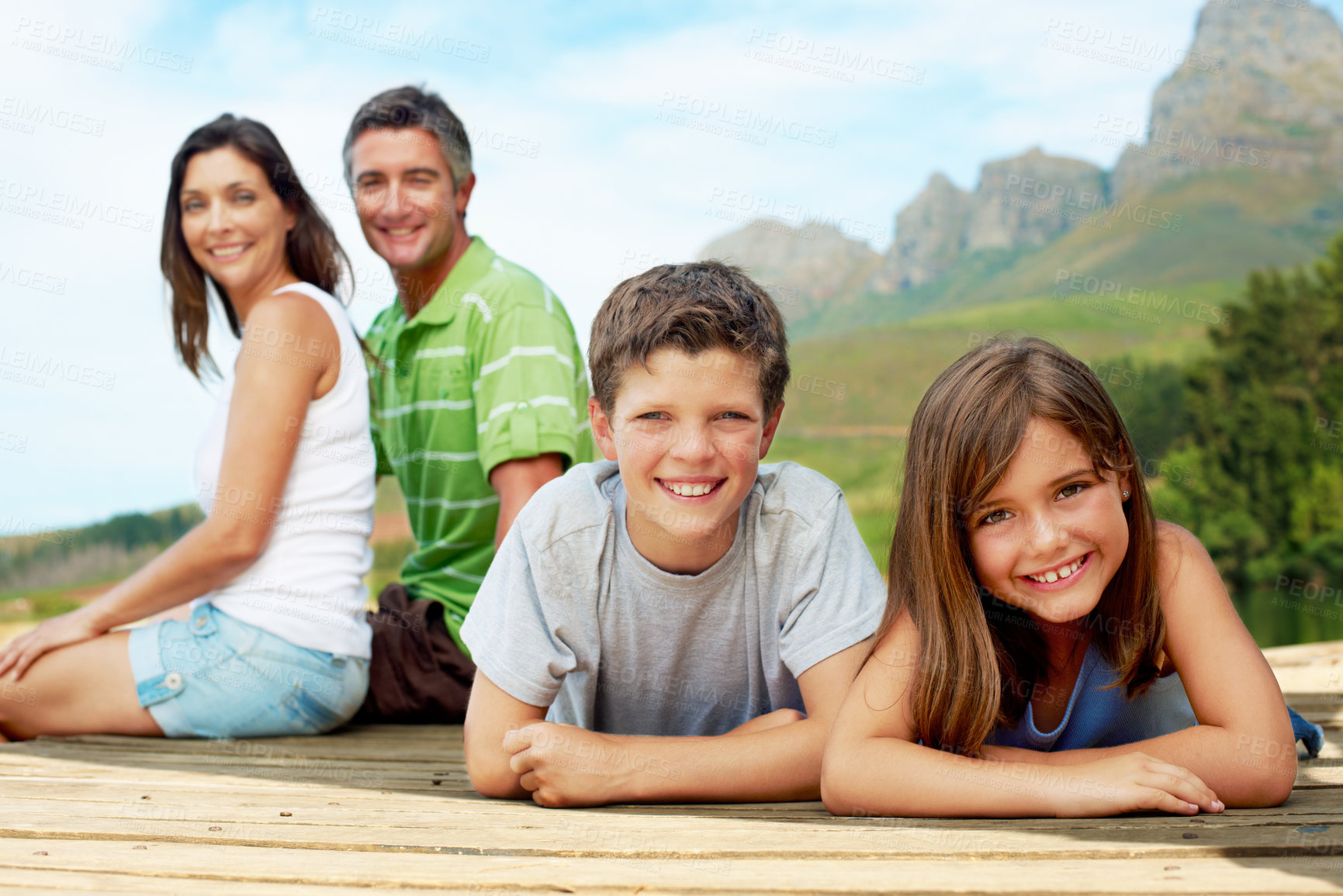 Buy stock photo Family, children and smile on dock for vacation with camping, bonding and relax in nature together. Mother, father and portrait with pier outdoor for holiday, summer trip and travel with forest