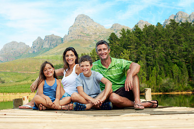 Buy stock photo Portrait, family and lake pier in countryside for summer holiday, bonding and happy together. Mountains, outdoor and smile of man, woman and children in nature to relax, vacation and connection