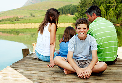 Buy stock photo Family, vacation and happy child on lake dock, relax and portrait outdoor for summer travel. Boy, teen kid and break at pier on holiday, countryside tourism and chill with parents by water in nature