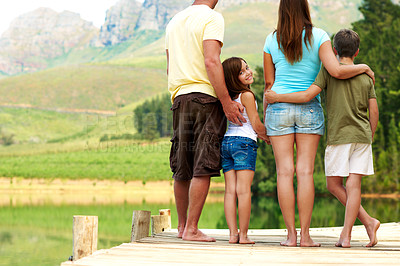 Buy stock photo Holiday, family or girl on pier with smile, bonding or loving connection for child growth. Back, parents or children with embrace, healthy relationship or getaway portrait in childhood development.