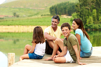 Buy stock photo Boy, happy and family on pier by lake for travel, together or bonding with summer vacation in nature. People, parents and male kid with portrait for holiday or break, relax and connection by river
