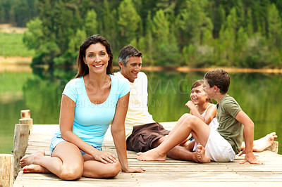 Buy stock photo Woman, travel and family on pier by water, together or bonding with summer vacation in nature. Mom, dad and children for holiday break, relax and happy portrait outdoor for fresh air by lake
