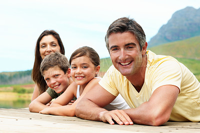 Buy stock photo Portrait, happiness and family in nature for travel, together or bonding with summer vacation. People, parents and kids with smile outdoor, holiday break and relax on pier for connection and getaway