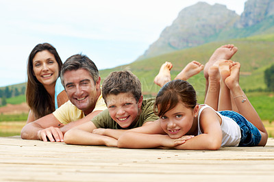 Buy stock photo Portrait, family and happy outdoor in countryside for summer holiday, vacation and together. Mountains, pier and smile of man, woman and children in nature to relax, bonding and connection or love